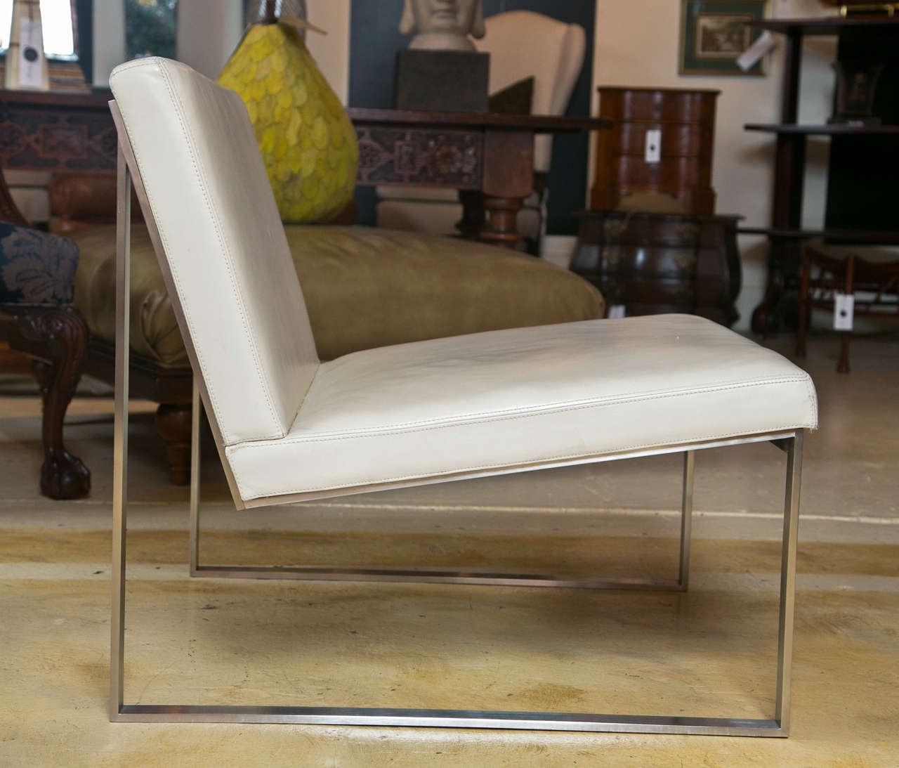 Pair of Milo Baughman style slipper chairs.  Flat bar steel and leather.  great pair of sleek polished steel an white leather chairs.  Soft leather in beautiful condition.