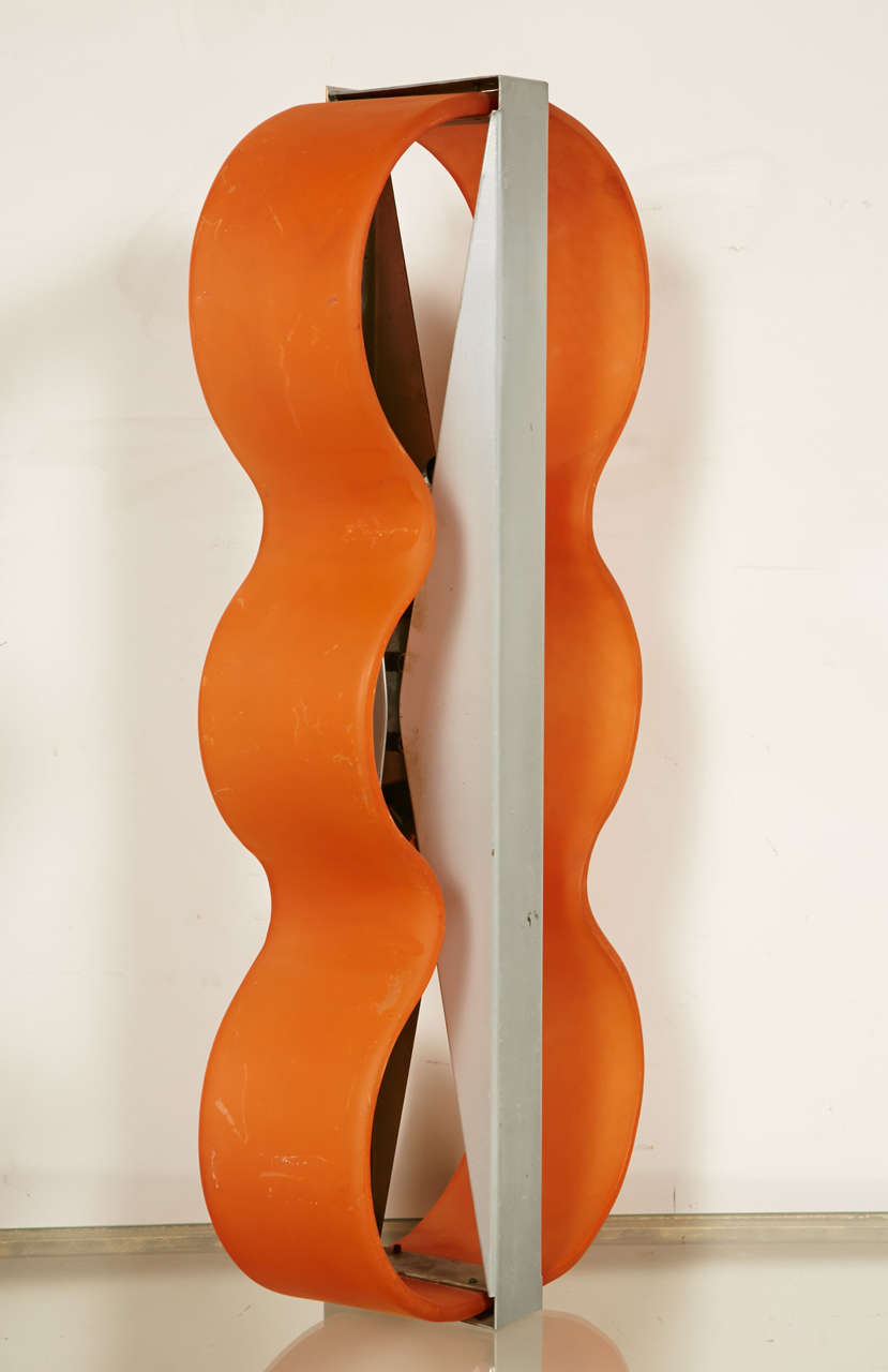 Unusual 1970s pair of sconces in wavy orange glass maintained by a metal structure. Items can be sold as a pair.