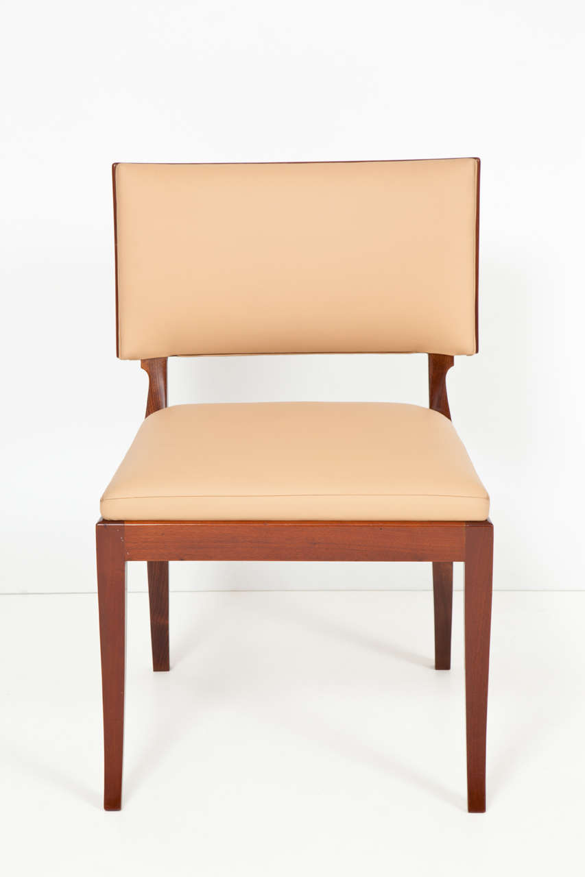 A Frits Henningsen mahogany and leather Klismos style side chair, the oversize rectangular backrest with a mahogany back and leather front, drop-in leather seat raised on sabre legs.