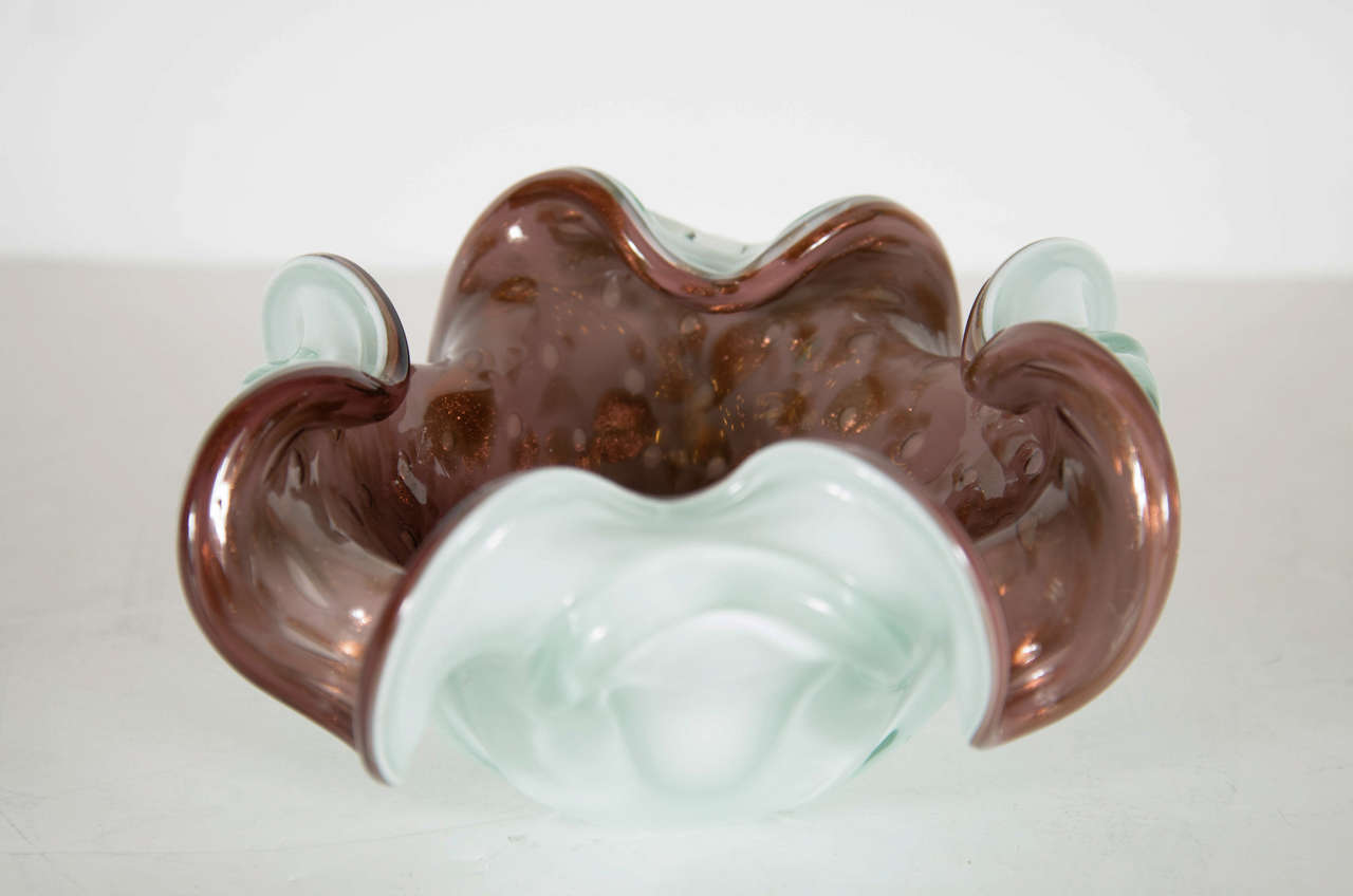 This stunning organic free form bowl features a rich aubergine murano glass with an off white exterior with murano glass decorative swirl and 24k gold accents.