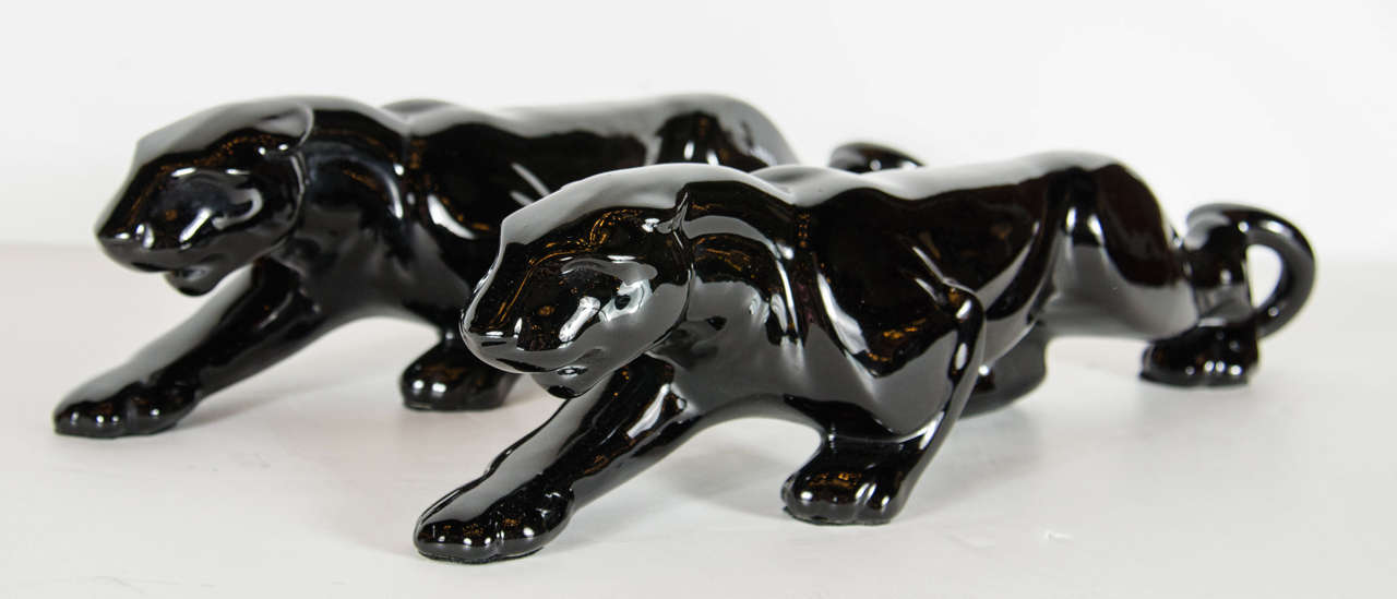 These gorgeous pair of panthers are sleek and streamlined in form and represent the Art Deco movement in America . They are black glazed ceramic and in perfect condition.