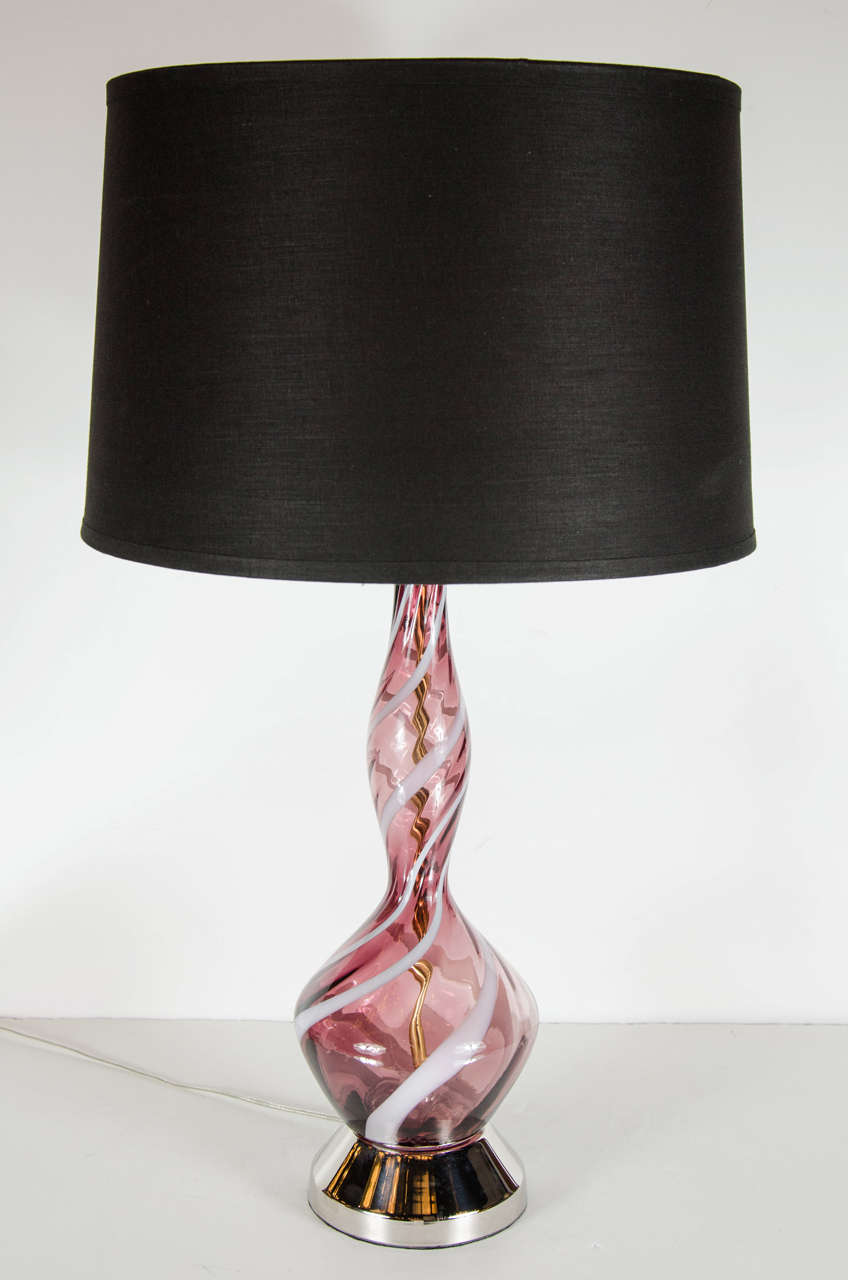 This gorgeous Mid-Century Modern lamp consist of Amethyst Murano glass with pearlescent swirls throughout. The glass bodies attach to radiant nickel bases. They have been newly new custom shades and newly rewired to American standards. Excellent