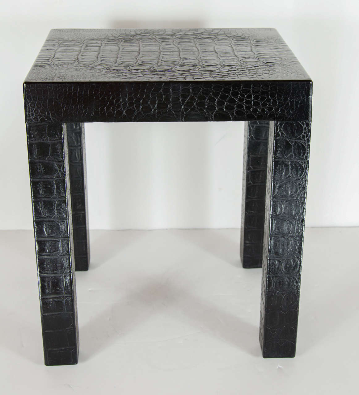 Ultra Chic pair of square parsons side tables are solid wood construction that have been clad in a rich black clad crocodile. Can be used separately as side tables or close to each other as a cocktail table.