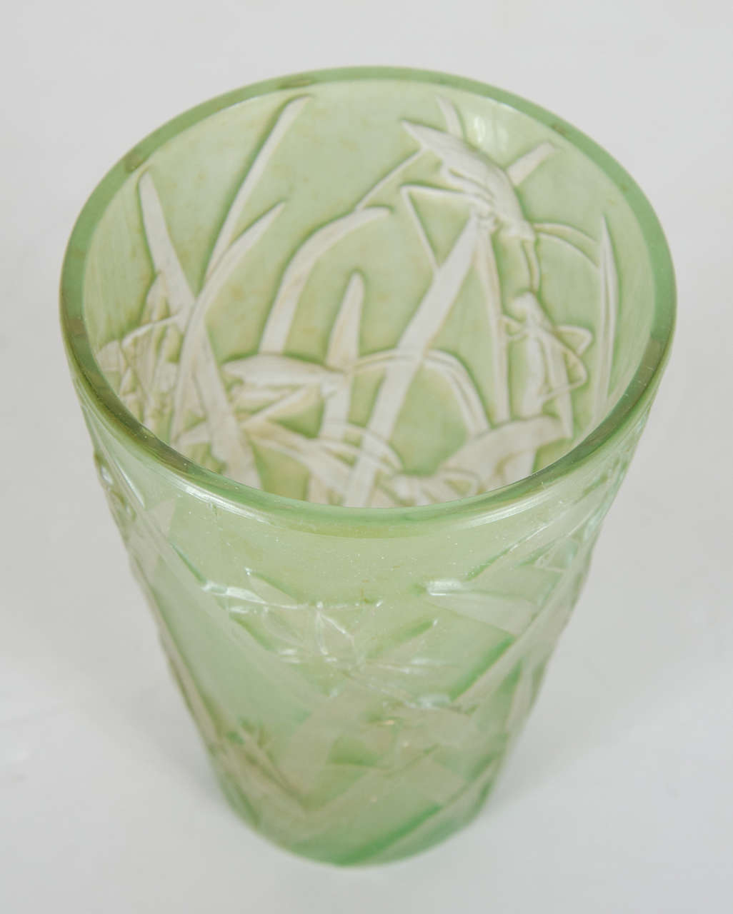 This gorgeous vase is decorated with green grasshopper ornamentation throughout with stylized floral designs.