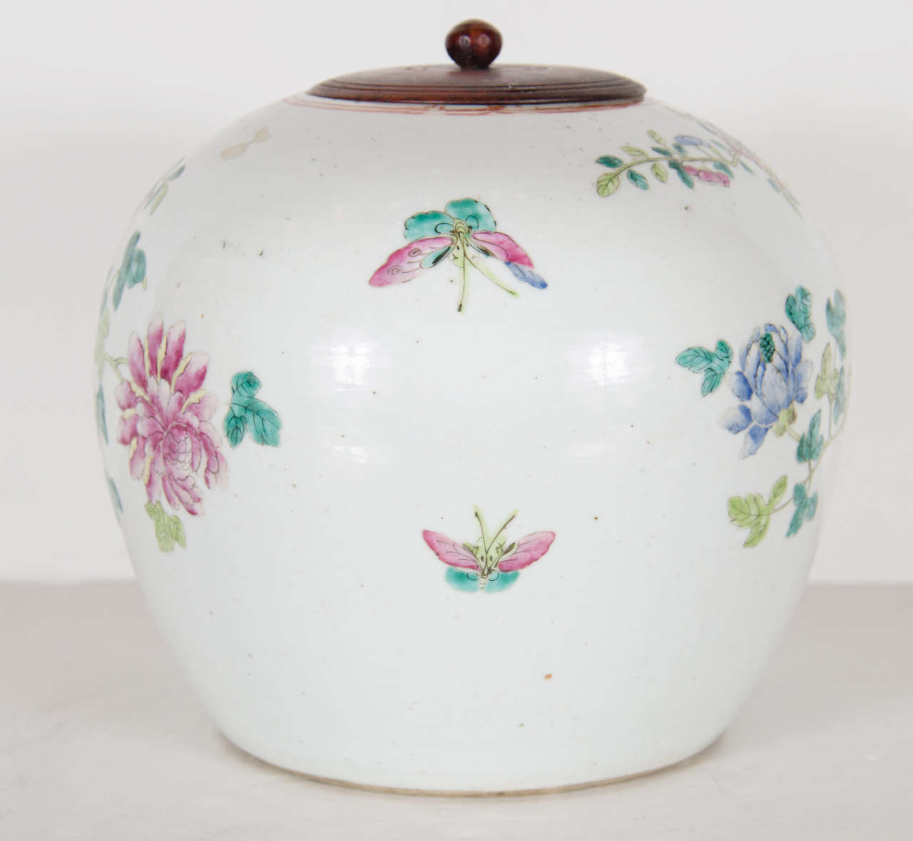 This exquisite urn features a covered wooden top with extensive hand painted exotic peacock with stunning plumage and floral and fauna decoration in colors of celadon, rose, cornflower blue, cerulean, peridot on a creme background.