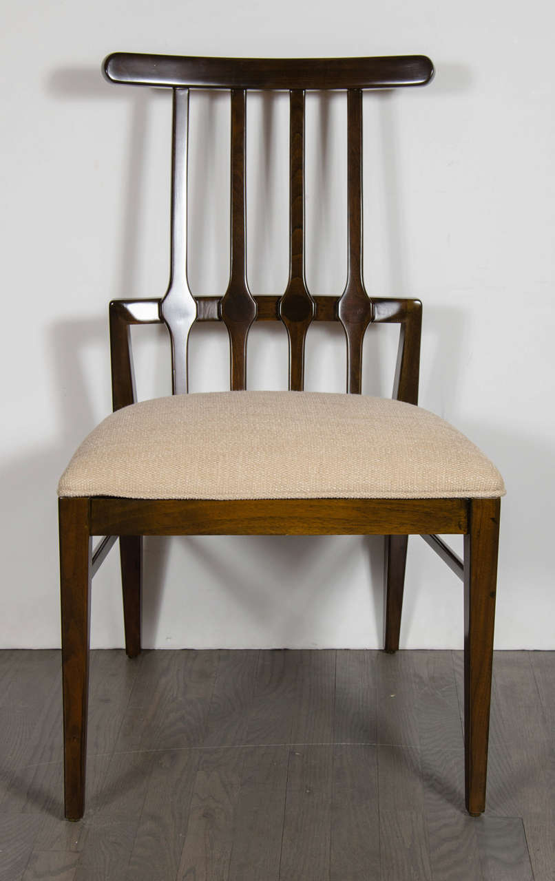 Mid-Century Modernist dining chair by Danish designer Niels Koefoed in a chic hand-rubbed Rosewood. This piece exemplifies the organic, yet streamlined design, for which the Scandinavians are renowned.  The back support boasts a continuous band that