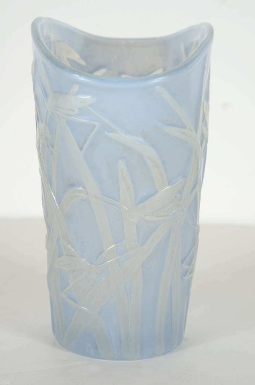 This rare vase features a pale blue with white grasshopper and foliage design throughout.