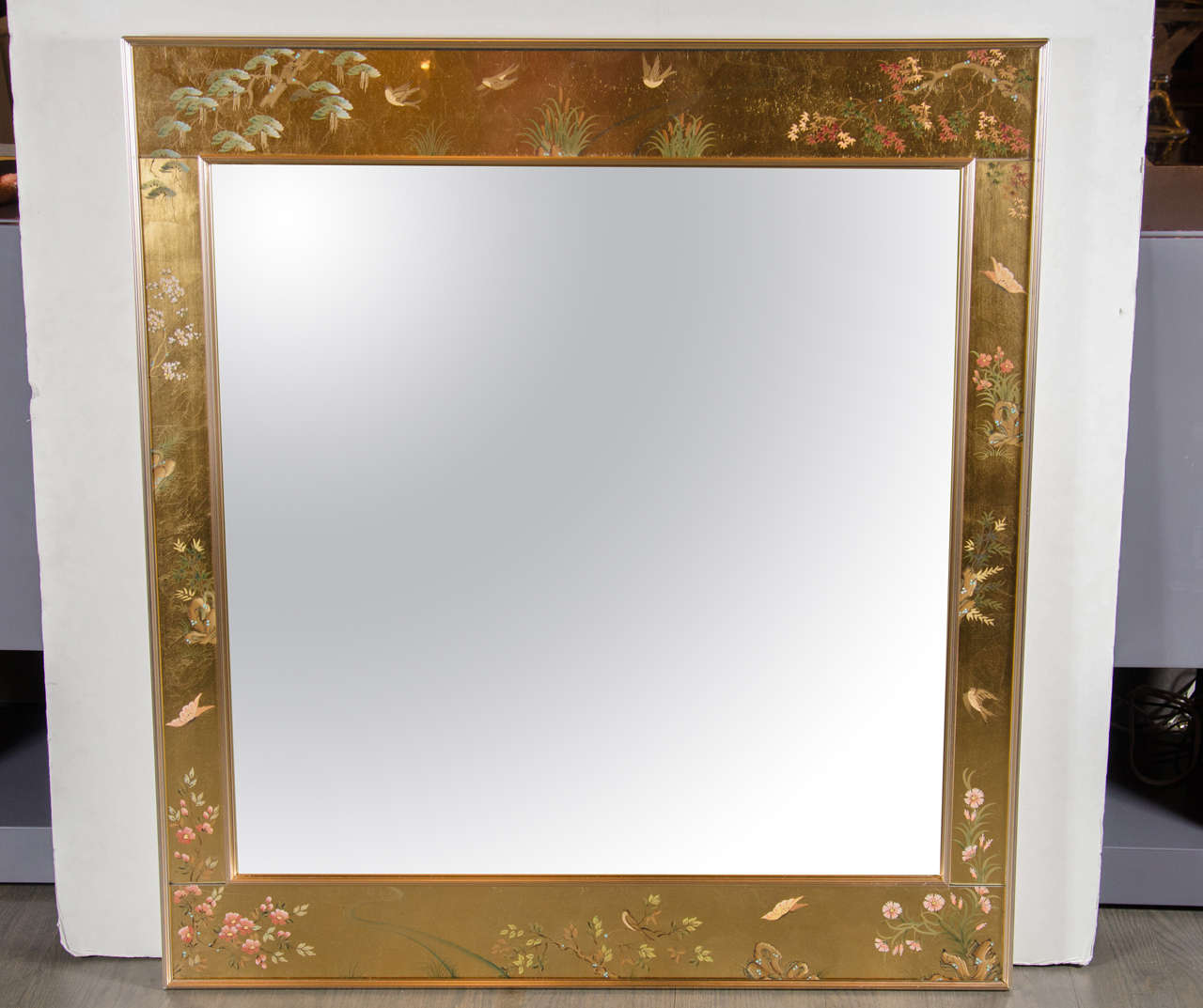 La Barge chinoiserie reverse hand-painted glass, gilt and églomisé mirror, signed Harriet Jansma, 1979. Beveled mirror with chrome anodized aluminum gallery style surround. The mirror is then framed by a painted chinoiserie scence depicting Cherry