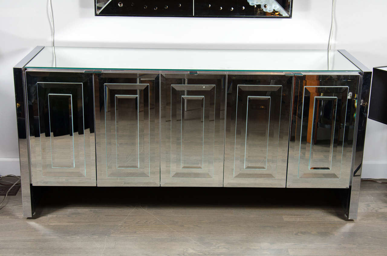 This stunning Mid-Century Modern mirrored and chrome sideboard was realized by the celebrated design firm Ello, in Italy, circa 1970. An iconic example from their 