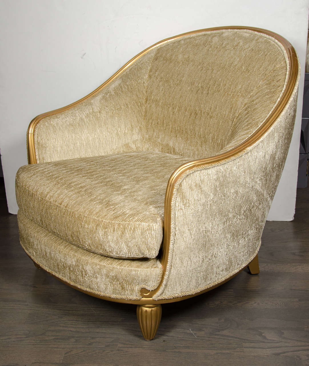 This gorgeous  pair of Art Deco club chairs by Sue Et Mare feature a moulded rounded frame and upholstered back above a loose cushion seat, on short bulbous fluted legs. Newly upholstered in velvet quill design, in mint condition. 
Louis Sue