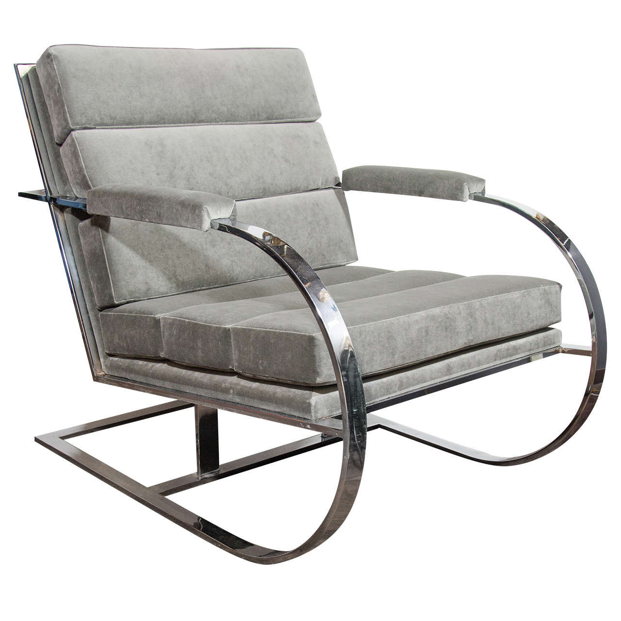 Exceptional large lounge chair with deep-seat design. Combines a curved cantilevered frame in heavy chromed steel with a luxurious horizontal channel tufted seat. The ample armrest, back, and seat are all upholstered in a luxe medium grey velvet