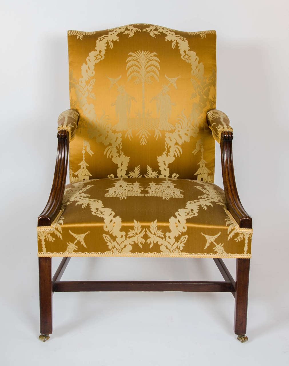 A good mahogany open armchair covered in a golden chinoiserie silk fabric.
The shaped reeded arm supports with scroll tops, the square section front legs and splay back legs joined by stretchers.
Re-upholstered and covered in a Fine golden