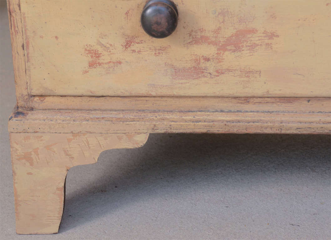 A good looking, early 19th century painted chest of drawers with original paint, original ebonized knobs and bone escutcheons, three drawers, bracket feet.