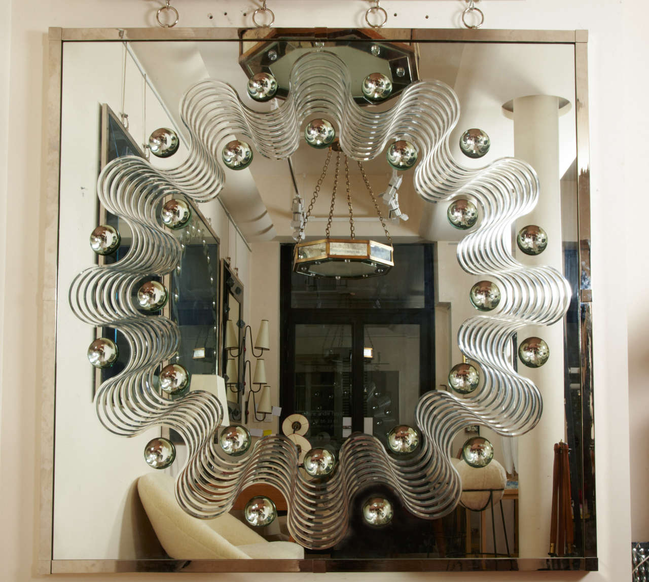 Spectacular large bubble mirror with engraved wave design and nickeled bronze frame and ring hanger.