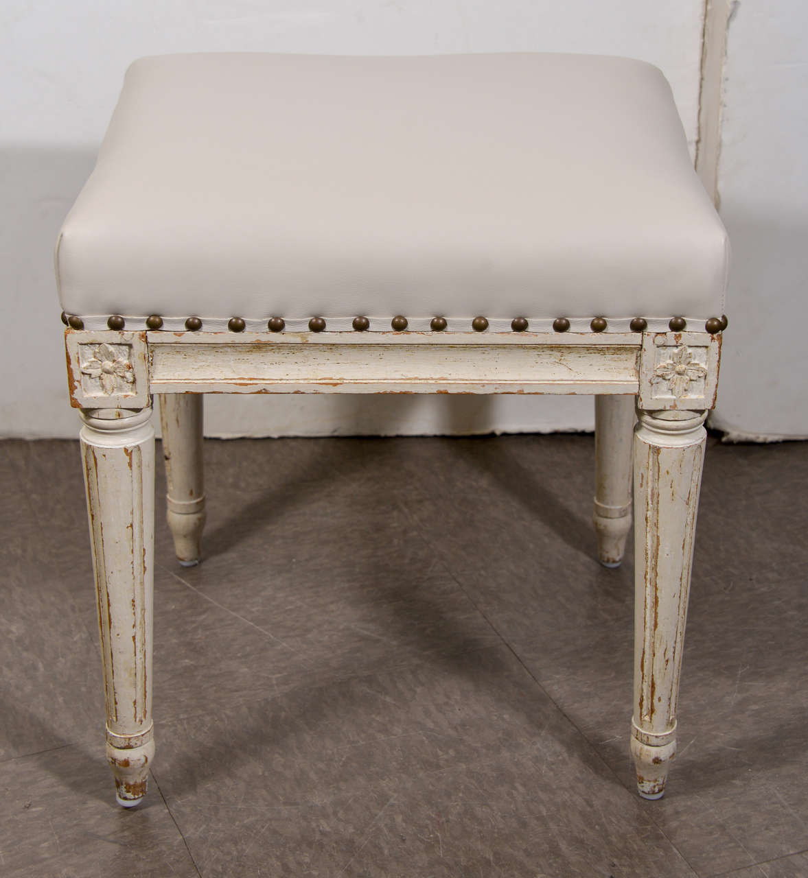Pair of painted stools in the style of Louis XVI, circa 1860. France. Newly upholstered in smooth leather.