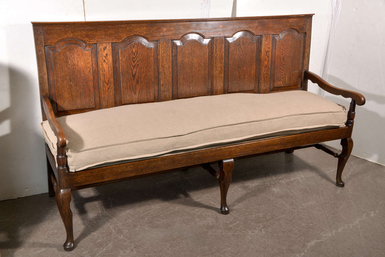 Queen Anne era carved oak settle, England, late 18th century. Measures: 72