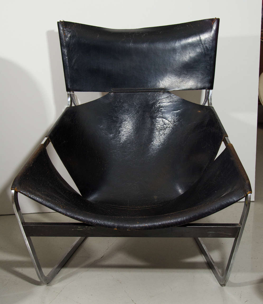 Pierre Paulin's chair for Artifort. Black leather draped over a chrome frame.