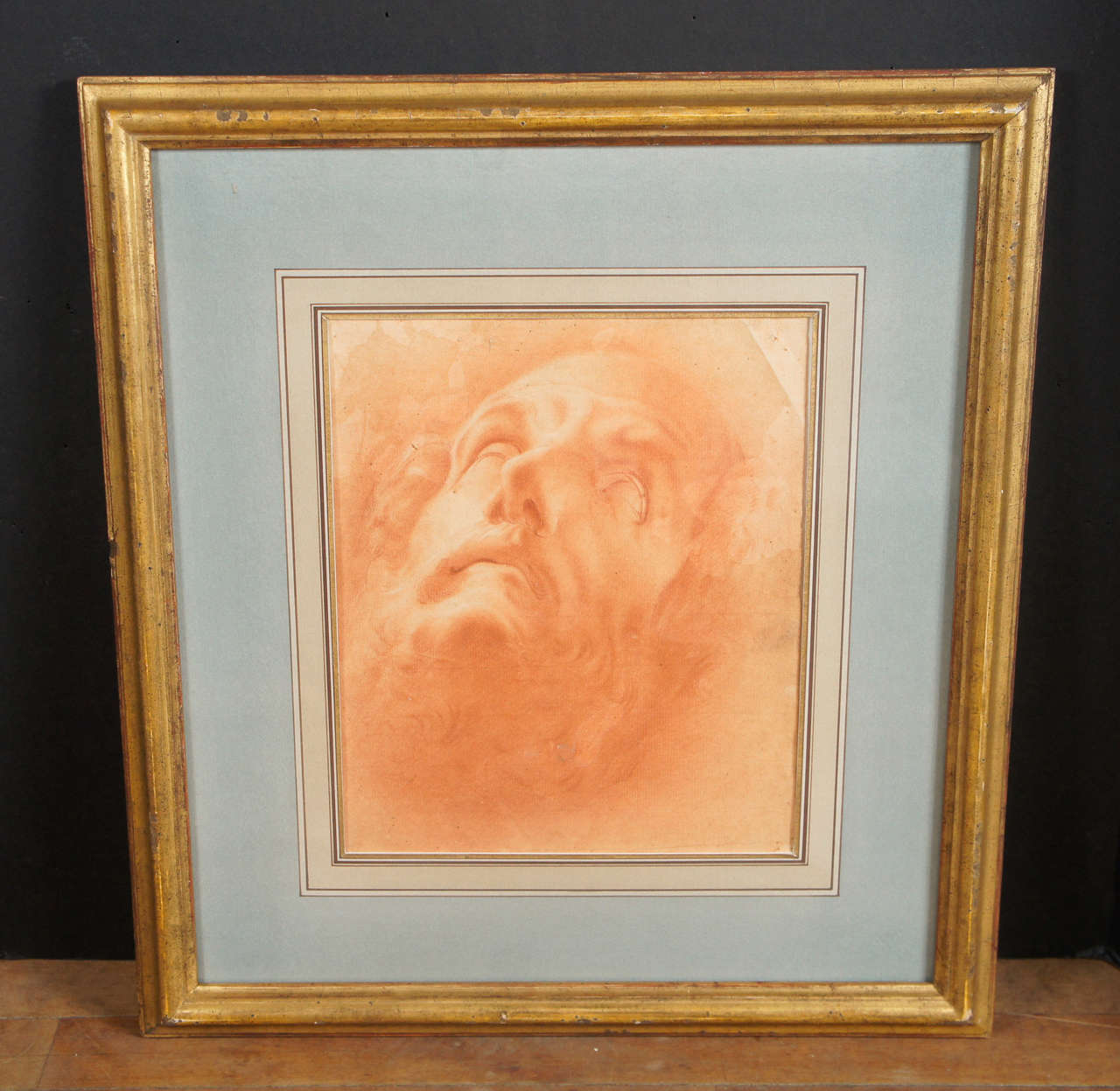 This very fine drawing from the early Baroque period is in Sanguine on laid paper. 
this Italian drawing in a rich brown-red is framed in a fine old gilded frame and has a beautiful old french matte. The image of the head of John the Baptist after