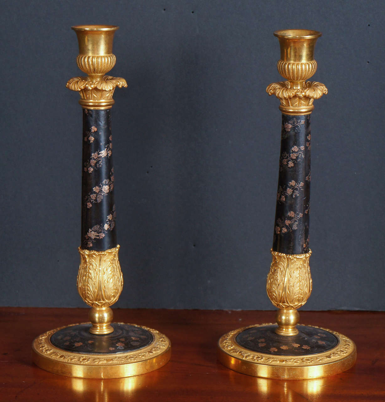 This fine pair of candle sticks made in France during the rein of Charles X,  circa 1820  represent the high style nature of goods made in the Pala royale district of Paris during the time. The casting is fine and very detailed and the extravagantly