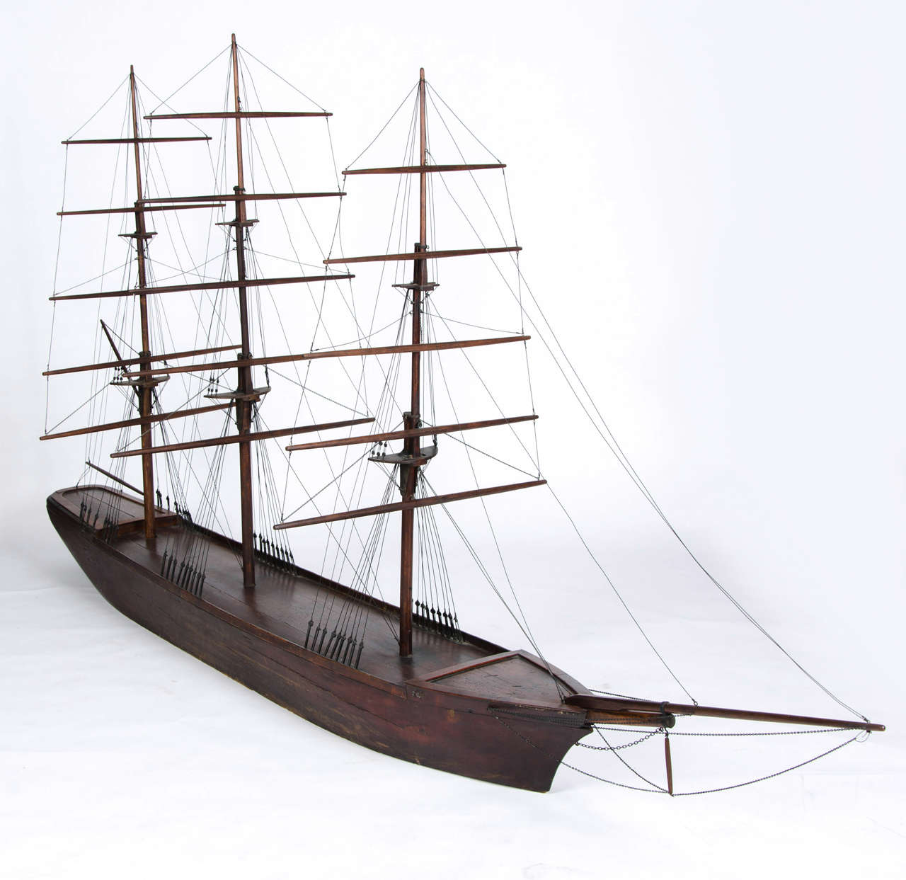 A rare large model of a three masted square rigged clipper with intricate rigging and solid flat bottomed hull.