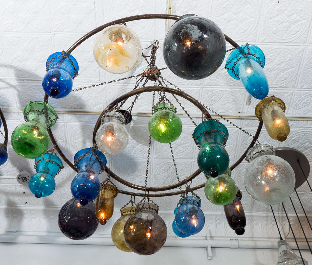 Two-tiered inverted handblown glass chandelier in assorted colors and sizes with bronze rings. Available in custom sizes and with silver finished rings.