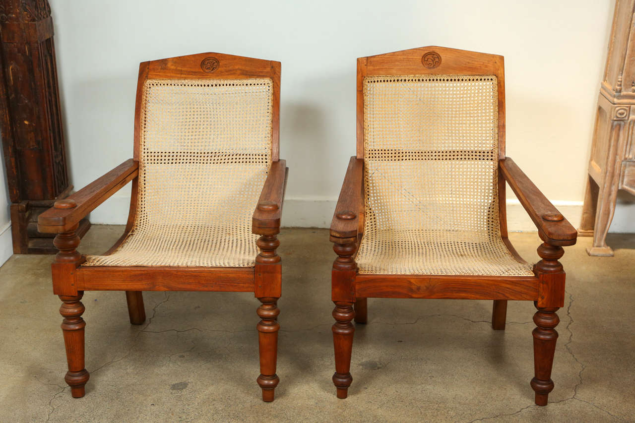Colonial Anglo-Indian plantation chair with turned wood legs, pivoting leg rests tuck under arms.
Caned in original good condition.
Chair is 27