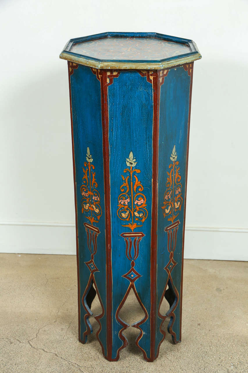 Pair of hand-painted Moroccan octagonal pedestals tables, blue with ocher and maroon floral designs.
Hispano Moresque Designs and colors are slightly different in the 2 tables..