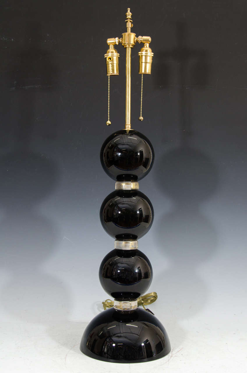 A vintage pair of midcentury black Murano glass stacked table lamps signed "Toso Murano" on the base.