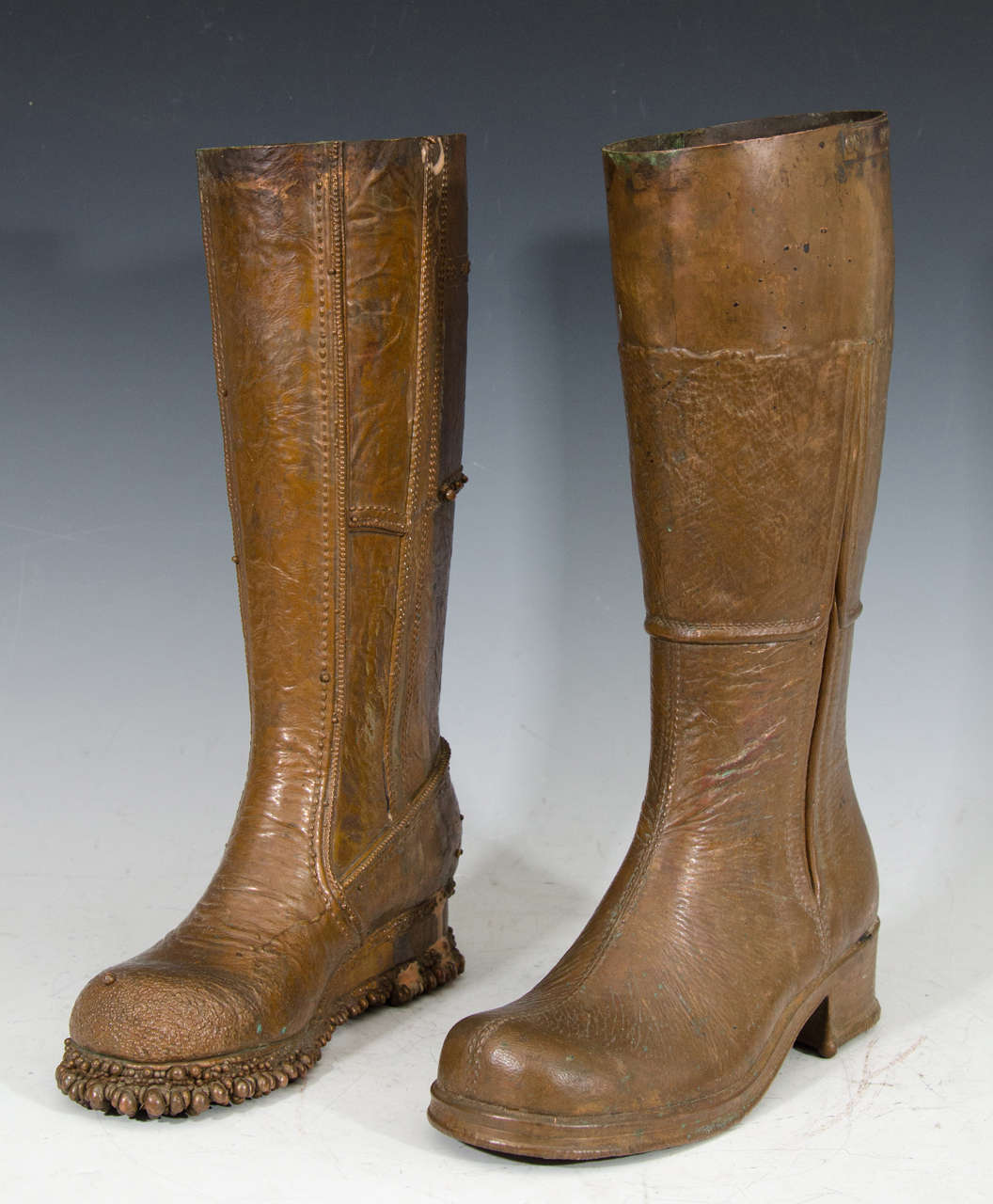 A vintage set of two Mid Century, unmatched, life-size bronze boot sculptures by Silas Seandel.  Good vintage condition with age appropriate wear.

Dimensions for boot dated 4/14/76: 16.5