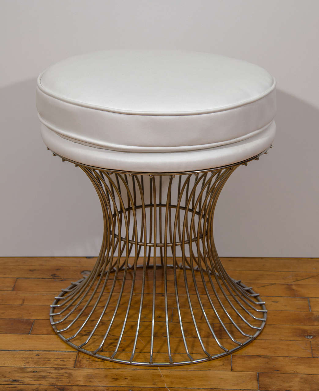 A vintage pair of white leather Mid Century stools with trumpeting wire bases in the style of Warren Platner. Newly reupholstered.
