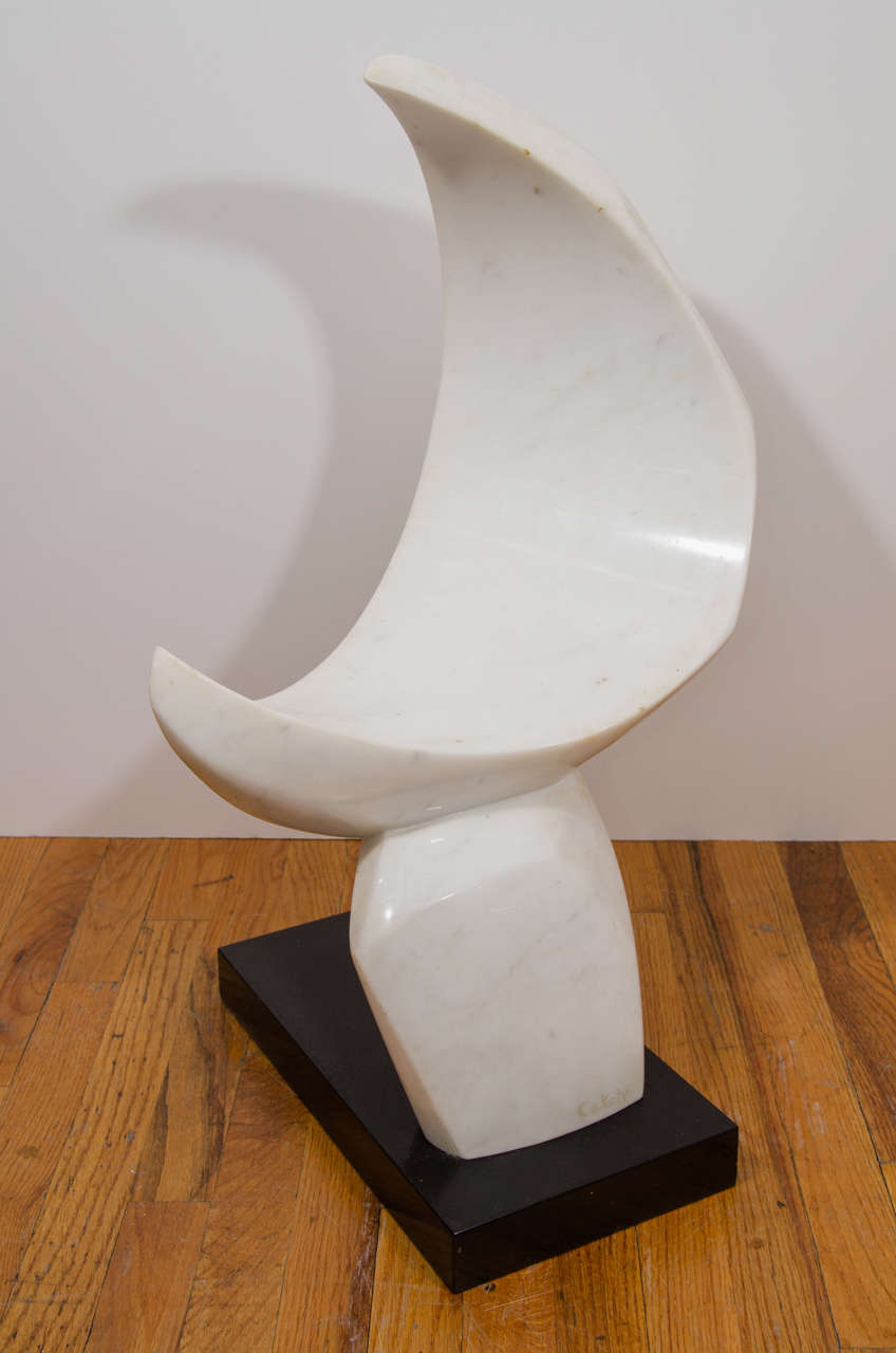 A mid century signed abstract carrara marble sculpture on a black base.  The top of the sculpture is crescent shaped or moon like.

Catherine “Catchi” Childs is a painter from  Manhasset, Long Island, New York.  She is the past president of the