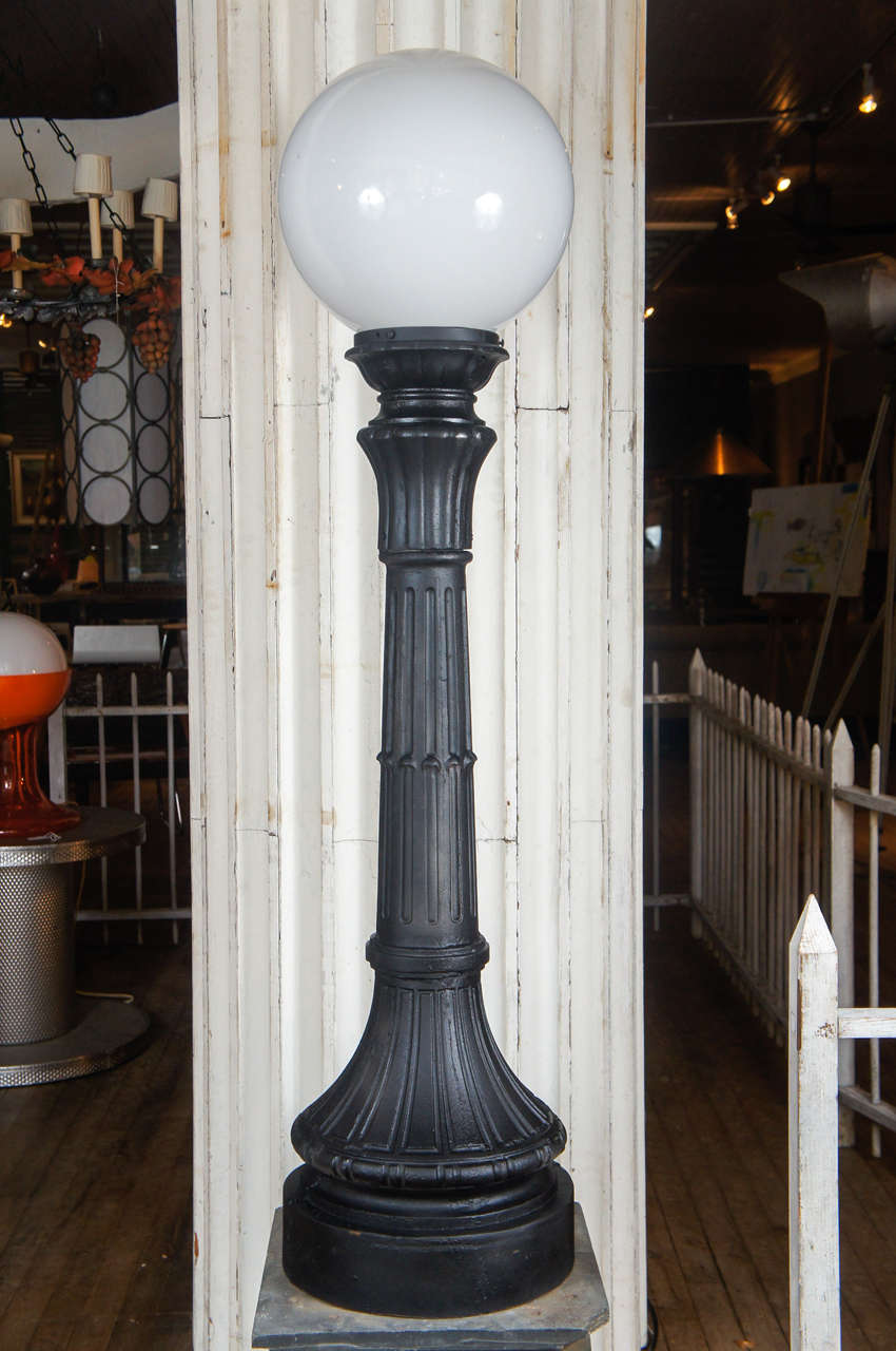 19th century cast iron exterior lamp posts, as found on municipal or mansion pedestals flanking the staircase, with milk glass globe.