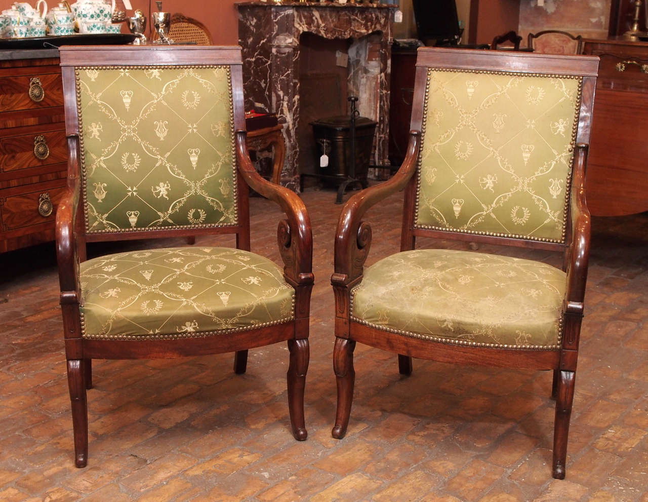 Pair of fine early 19th century French Restoration mahogany fauteuils with scroll arms and sabre legs, circa 1835