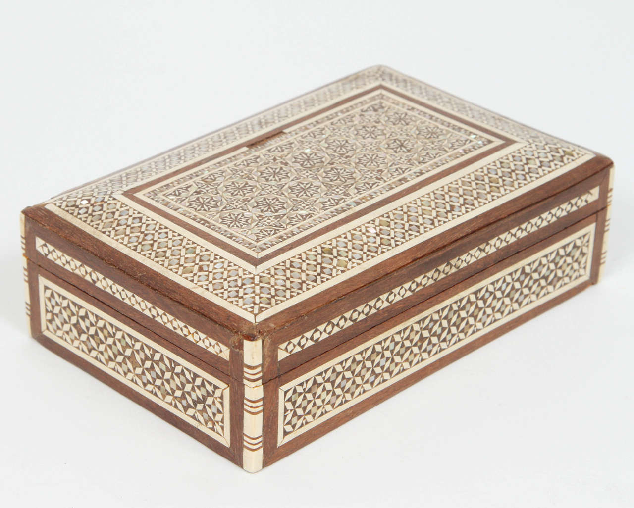 Antique Syrian box inlaid with mother of pearl, ivory and ebony.
Handcrafted very fine Moorish micro mosaic inlaid geometric marquetry artwork.
These Middle Eastern boxes are used to store cigarettes or card.
Museum piece like the one in Doris