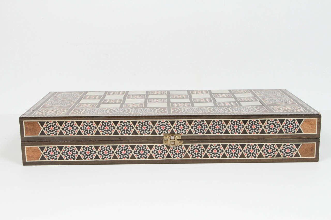 Large Syrian inlaid mosaic backgammon game.
Great inlaid wooden micro mosaic Middle Eastern box with backgammon and checker game box.
Finely hand made and inlay with fruitwood and mother of pearl .
Good condition and great Moorish geometric