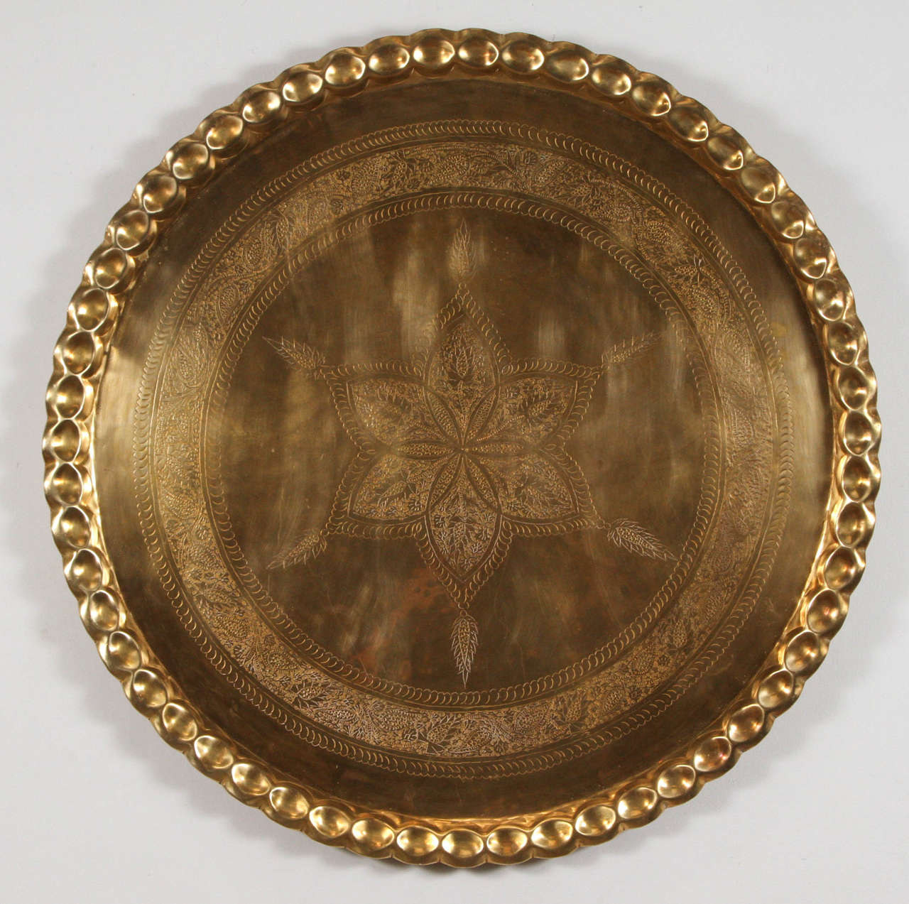 Large 36" diameter, heavy solid polished brass tray platter, 
Fabulous Moroccan brass tray, could be used as a decorative Middle Eastern piece hanging on the wall, or as a brass tray on an ottoman or table.
The brass tray is delicately hand