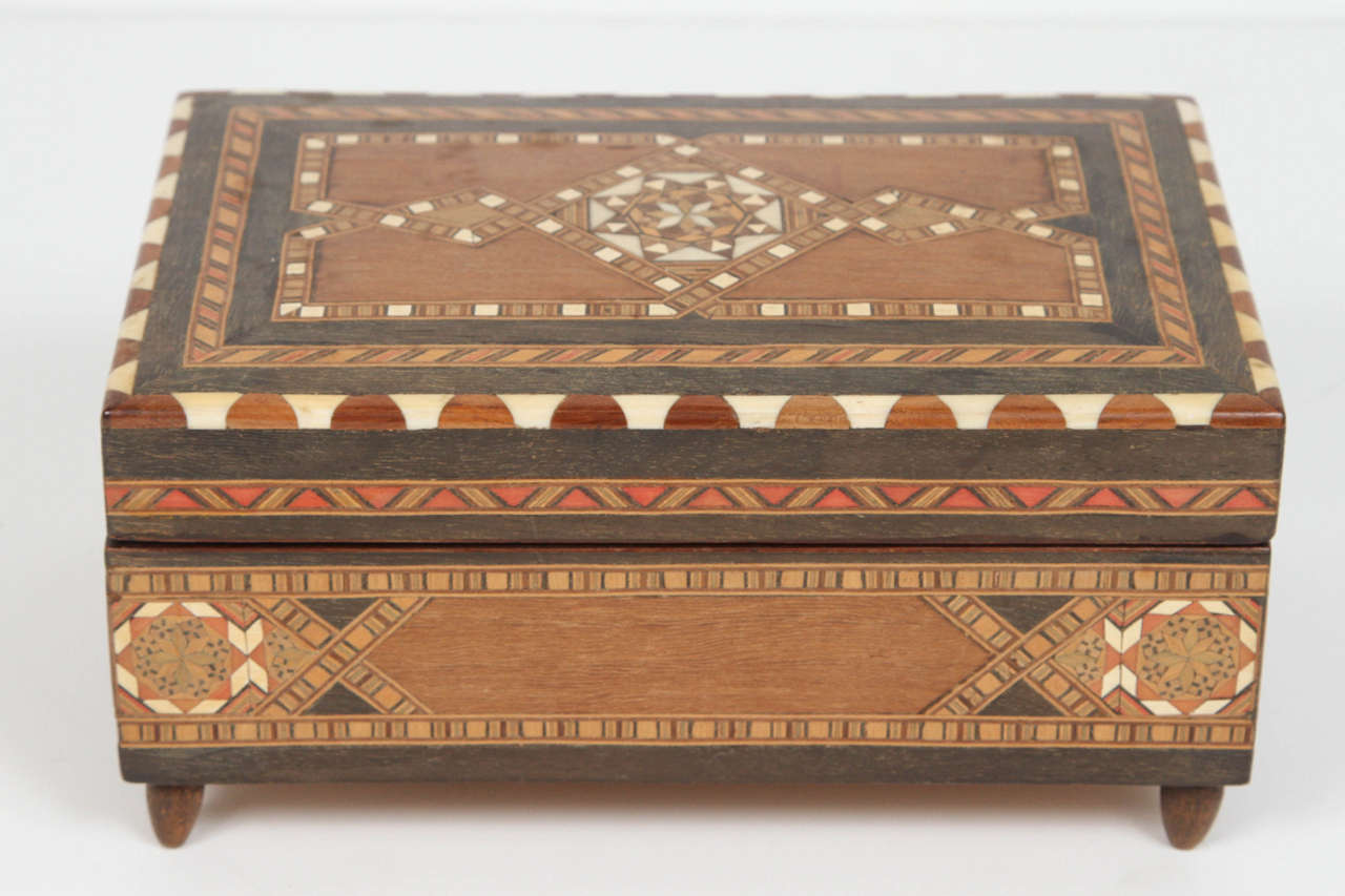 Spanish inlaid Marquetry music box, cigarette box.
Handcrafted in Spain in the Moorish Syrian style.
Finely inlaid in Islamic Moorish geometric designs with ebony and bone and other precious wood.
When you open the box, the music plays.
Very