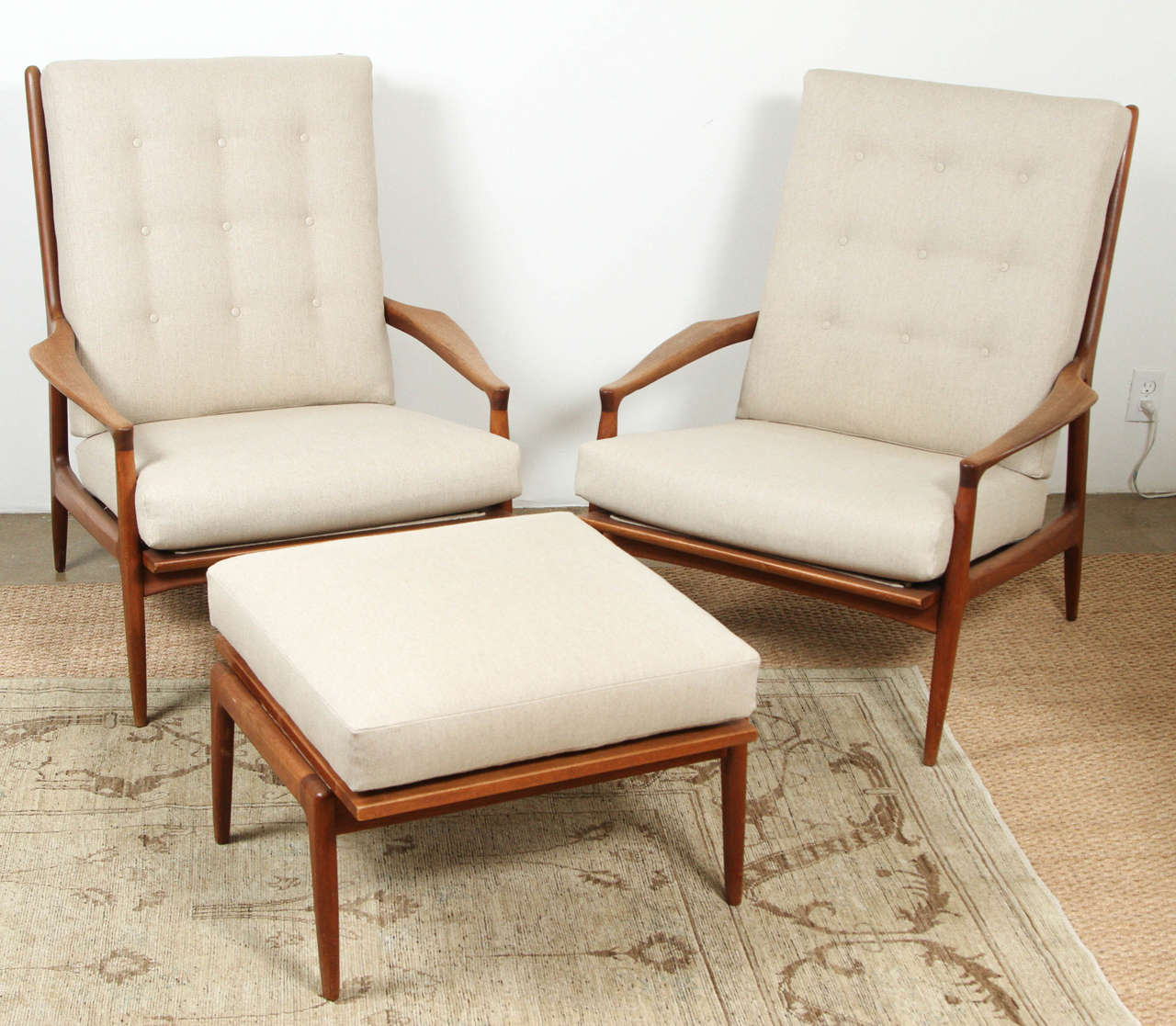 Pair of high backed beautifully sculpted Milo Baughman chairs. With tufted beige linen back and seat. Sculpted arms and back with see thru component. Stately and stunning! And very comfortable.