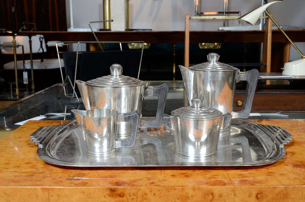 Silverplate coffee and tea set with original matching tray made by Ercius. France, circa 1940.

Five piece set includes coffee pot, tea pot, creamer, sugar bowl with cover, and tray

Signed/stamped with maker's marks.