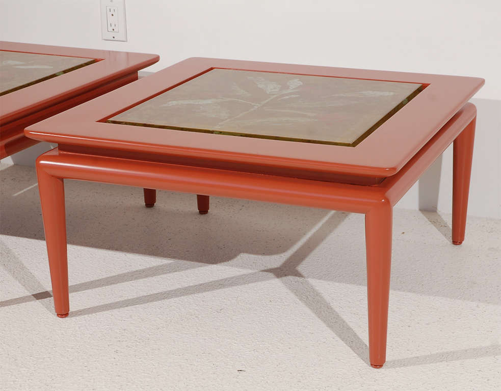 A pair of custom made side tables, most likely by Monteverdi-Young, finished in a deep salmon gloss.  The tables feature unique decorated glass tops by artist Dube for Fontana Arte.  Examples are signed.