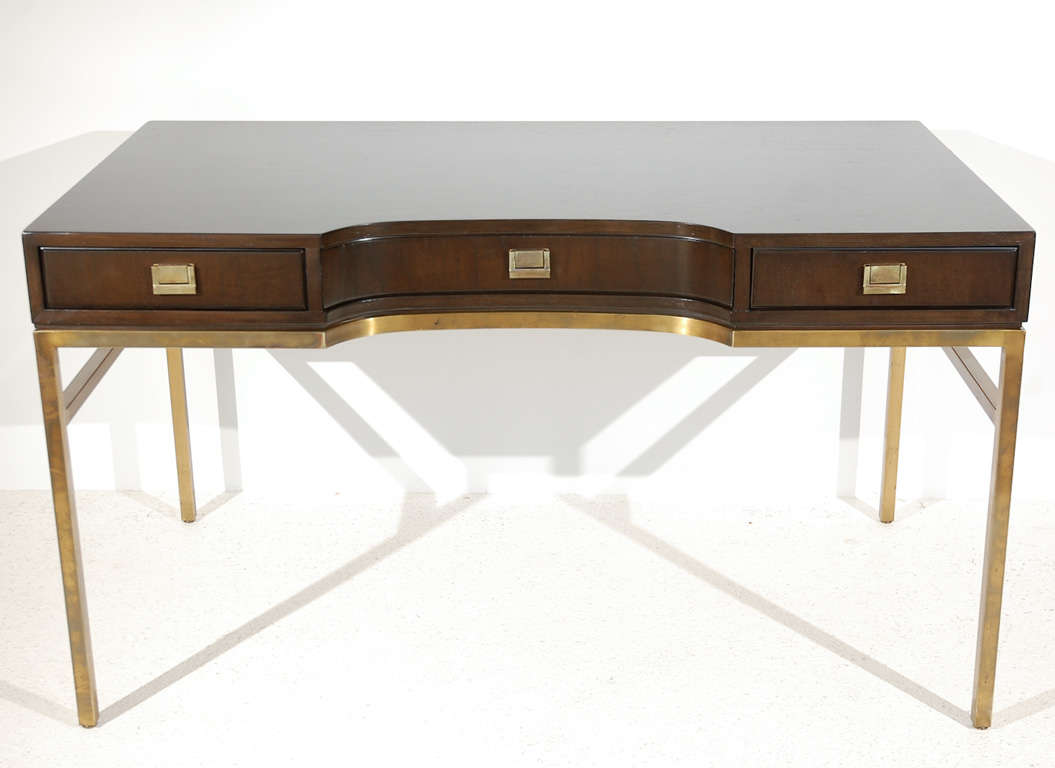 A glam dark wood three-drawer desk top with brass hardware set atop a brass base. Stamped with Drexel's maker's mark inside the left drawer (see Image 4).