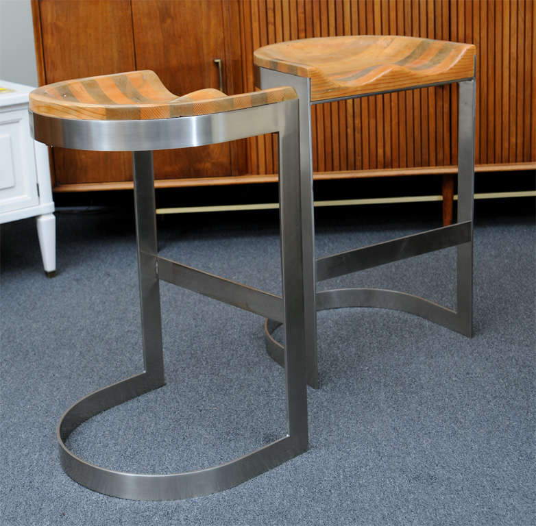 SOLD DEC 2012 Rare and distinctive Warren Bacon bar stools with a brushed chromed metal base and carved saddle oak seat, very often attributed to Milo Baughman, these unique bar stools were designed by Warren F. Bacon, a California designer and