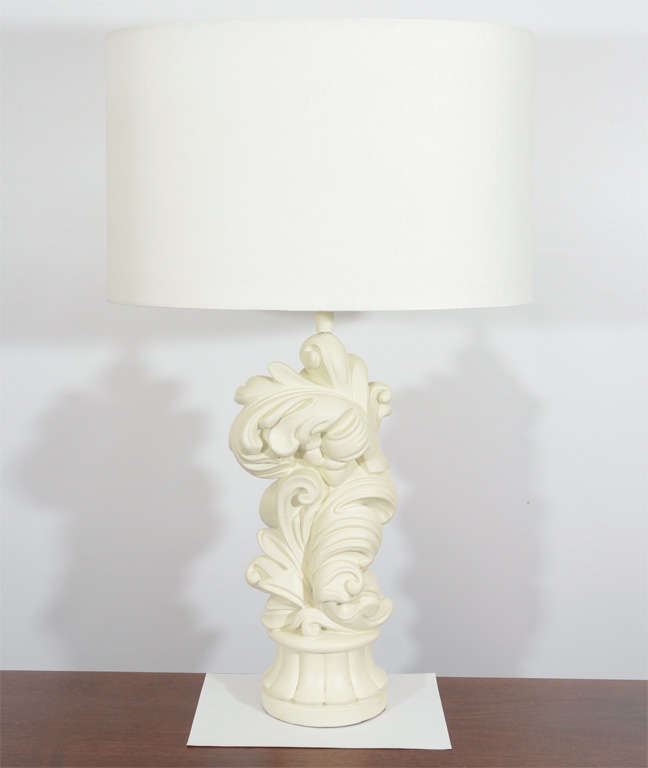 Glamorous pair of Chapman lamps in a Baroque decorative modern motif. They are a beautiful creamy white with oval lamp shades. They were once part of the original décor of Miami Beach's Eden Roc Hotel. Gorgeous! Please contact for location. Offered