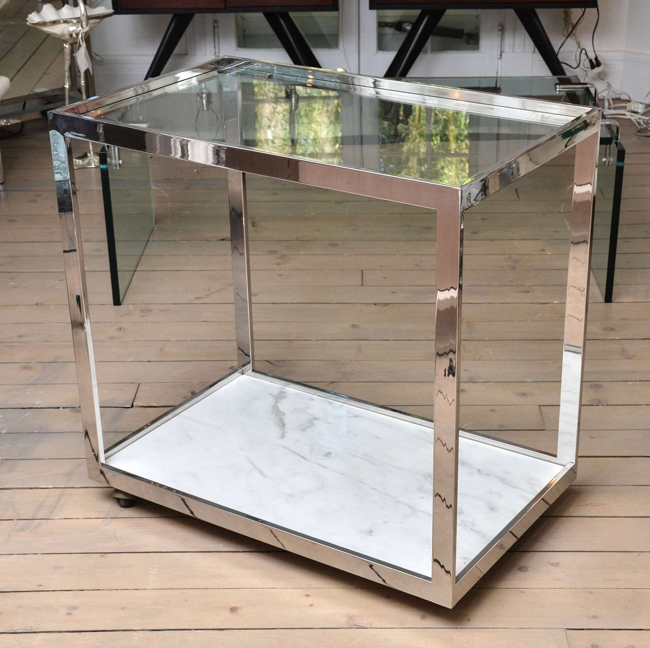 Wheeled Chromed steel and glass Milo Baughman bar cart.