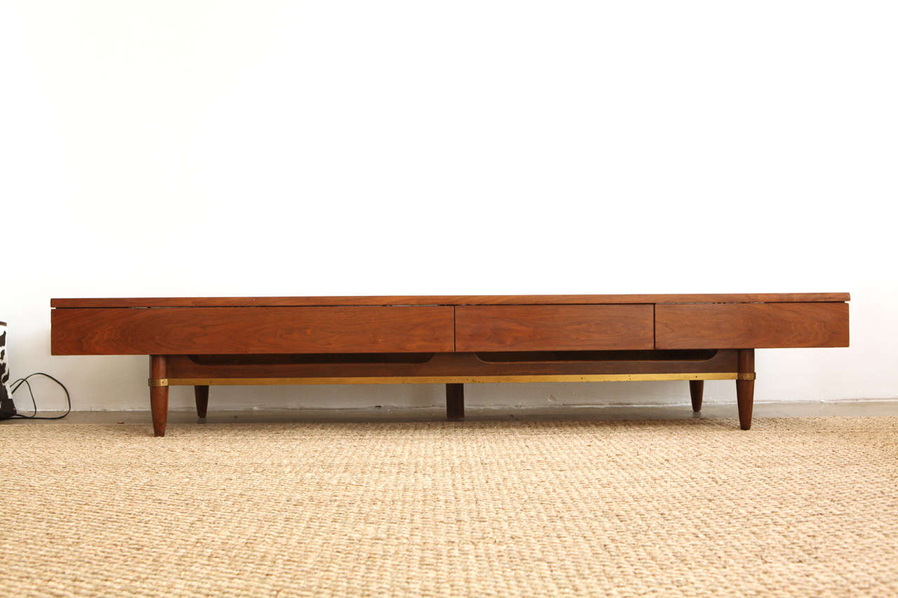 Gorgeous long and low walnut table by American or Martinsville. This wonderful coffee table would also make a great bench or TV stand.