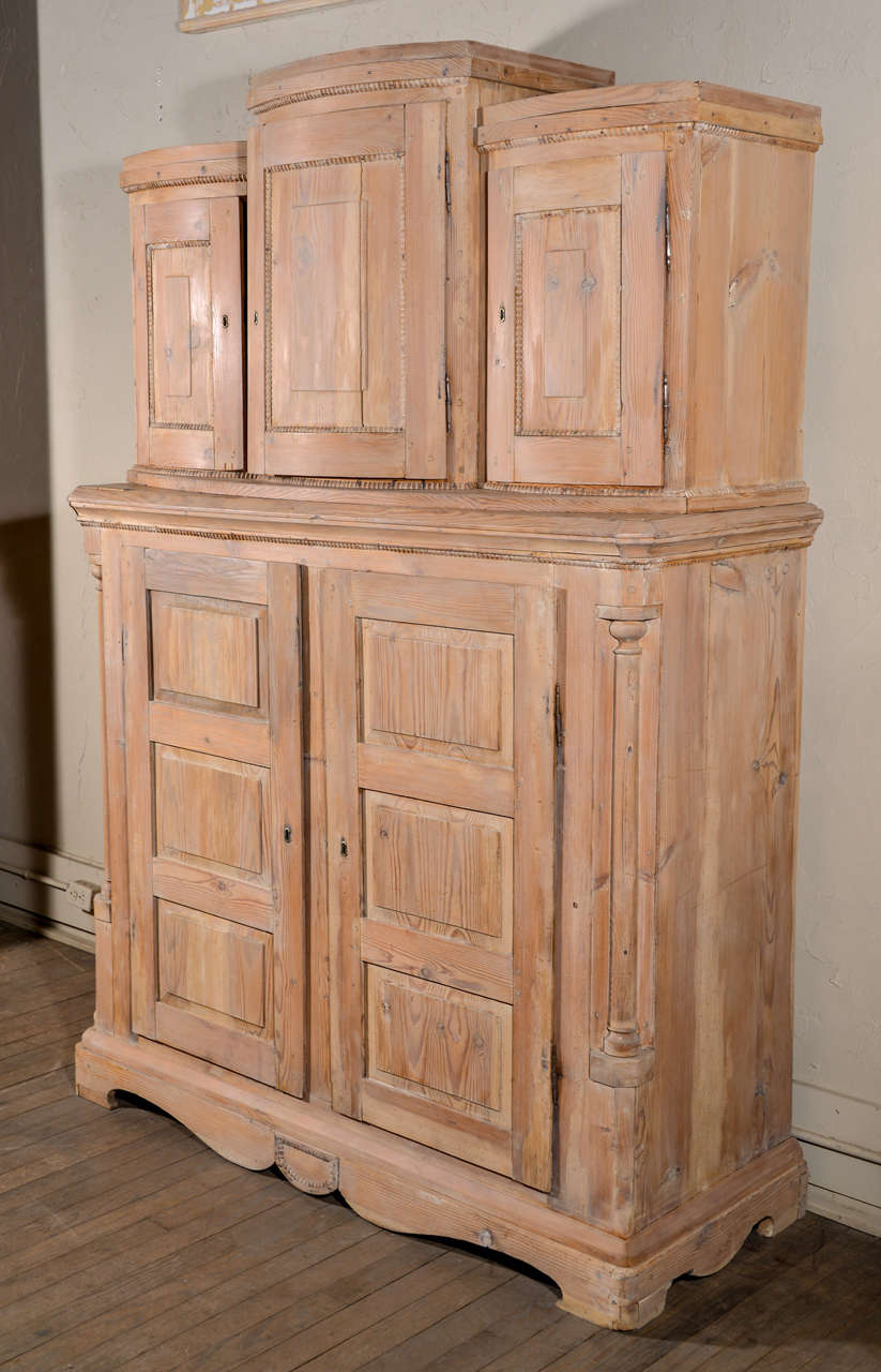 Large antique two-piece washed pine cabinet with blue painted interior (later paint).