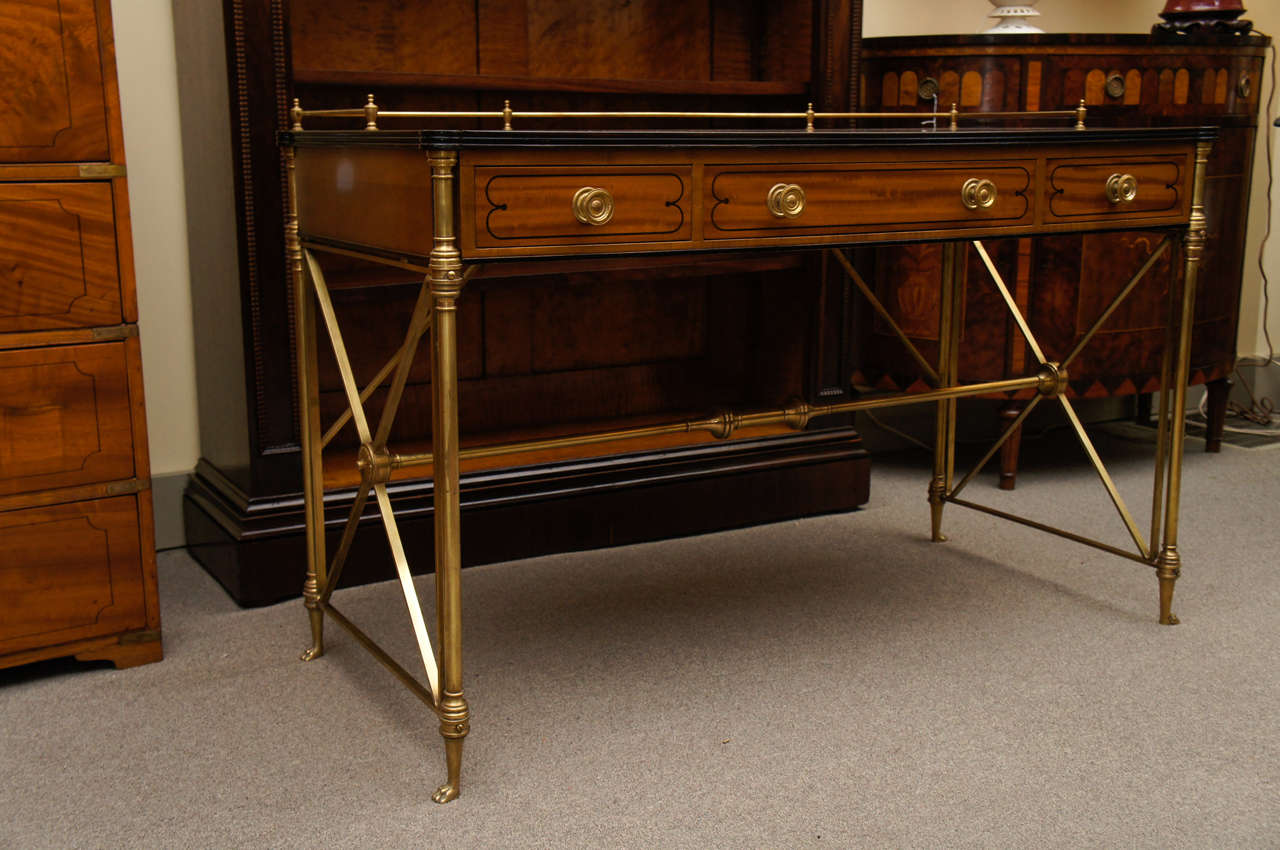 Rose and satin wood desk with ebonized details on all three drawer fronts with brass pulls and gallery on brass frame support. 