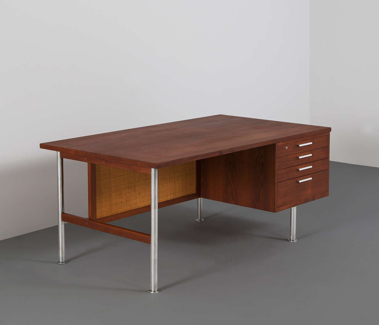 Rare Kai Kristiansen Desk in Teak, produced by Feldballes Møbelfabrik. 

The desk shows interesting lines and a graphic forms. The combination of teak, woven cane and chromed steel legs provide a nice subtle contrast, which makes this desk a real