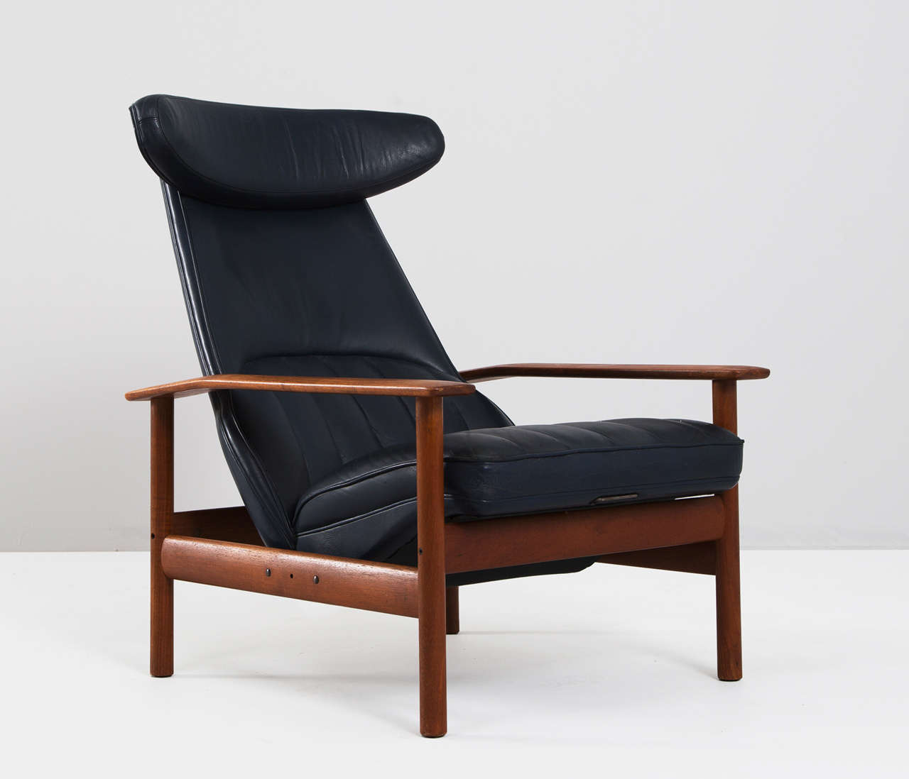 Beautiful Easy chair by Sven Ivar Dysthe with solid teak frame.
The chair is adjustable in two positions to maximize comfort.

The seat is covered in its original dark blue skai in a 'channeled' technique
which gives these chairs a very nice and