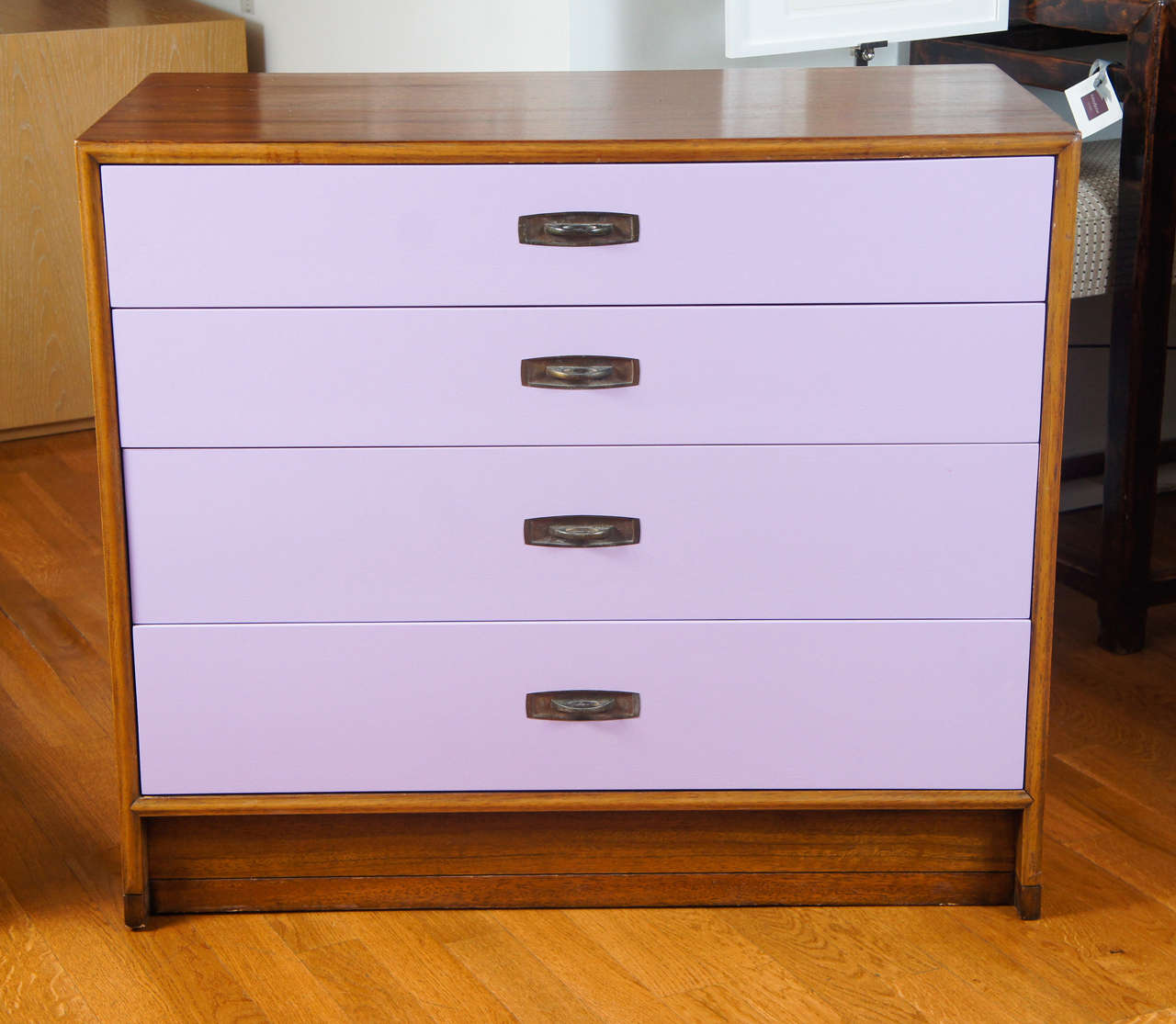 Midcentury four-drawer dresser with unique bronze drawer pulls.
Newly lacquered drawer fronts in a lovely shade of lilac.
Signed Drexel.